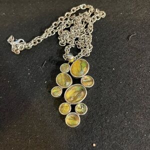 Signed Lia Sophia green and silver tone pendant on a long chain.